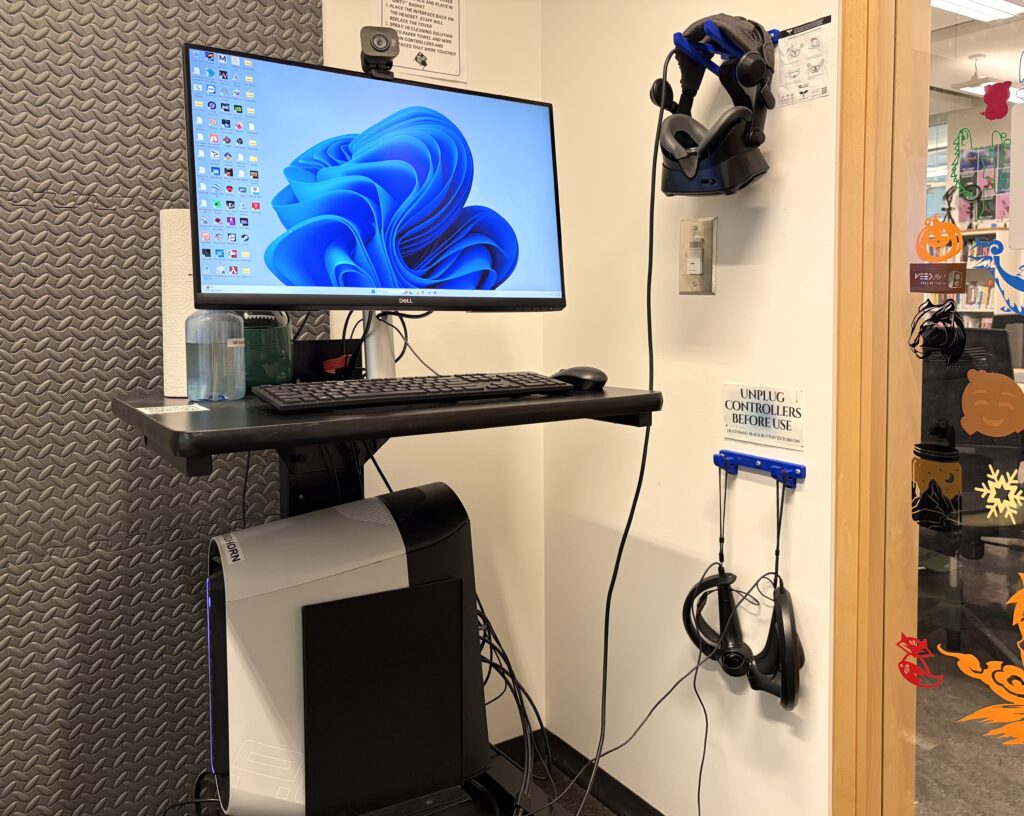 The VR station at the TRU Library Makerspace, featuring a headset mounted on the wall alongside a dedicated PC. Students can use the headset during open hours with no prior experience required. (Singh, 2026)